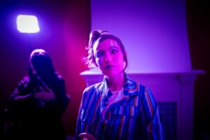 woman in clown makeup with a confused look on her face.